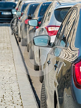 Aligned parallel parked cars on the side of the street or road