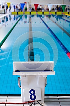 Aligned swimming starting block and platform with number