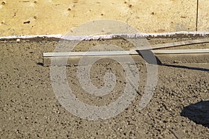 alignment of fresh concrete slab with special working tool