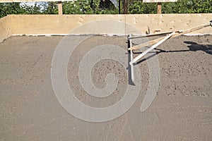 alignment of fresh concrete slab with special working tool