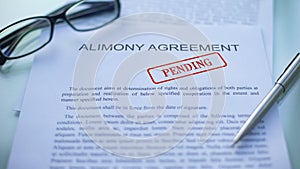 Alimony agreement pending, officials hand stamping seal on business document