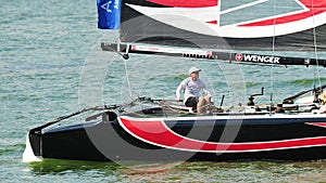 Alinghi skipper steering boat at Extreme Sailing Series Singapore 2013