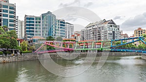 Alkaff Bridge on the Singapore River at Robertson Quay with dark gray clouds timelapse hyperlapse