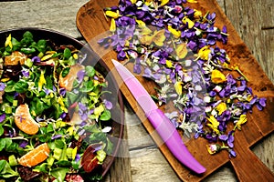 Alkaline, healthy food: salad with flowers, fruit and valerian salad photo