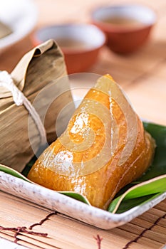 Alkaline rice dumpling zongzi - Traditional sweet Chinese crystal food on a plate to eat for Dragon Boat Duanwu Festival