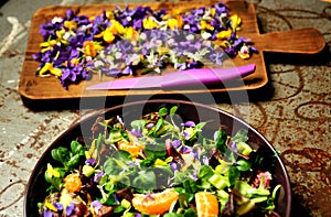 Alkaline, spring salad with flowers, fruit and valerian salad