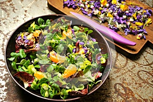 Alkaline, spring salad with flowers, fruit and valerian salad