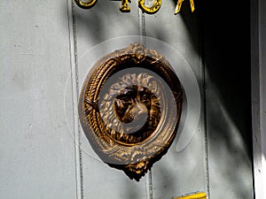 A Brass Door Knocker Hangs on the Door of a Home in the New Orleans French Quarter