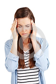 When it all becomes too much...Studio shot of an attractive young woman suffering from a headache against a white