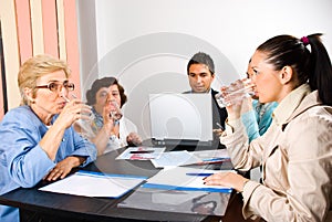 All business people drinking water at meeting