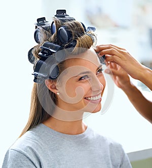 All about curls. A beautiful young woman spending the day getting her hair and makeup done.