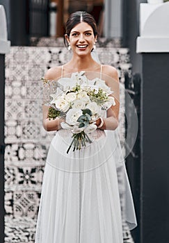 We all dream of this day. a beautiful bride standing outside.