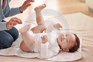 All dressed up and ready to roll. a woman changing her adorable baby girls diaper at home.