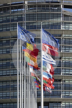 All EU Flags European Union flag waving in front of European Parliament, headquarter of the European Commission European