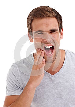 All that eyecandy might give you toothache. a man holding the side of his face in pain while standing in studio-isolated