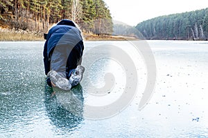 On all fours crawling child on the ice is very slippery