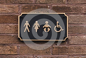 All gender restroom sign on wall in  Black  and Gold with letters and frame, WC - Toilets icon in public restroom sign with a male