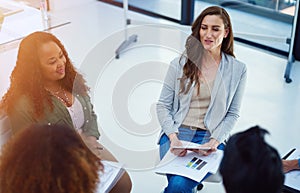 They all have a hand in reaching a solution. a team of colleagues having a meeting in a modern office.