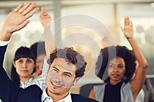 We all have some interesting questions. businesspeople hands raised asking questions during a seminar.