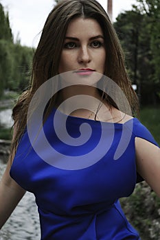 A business woman in blue dress in the park photo