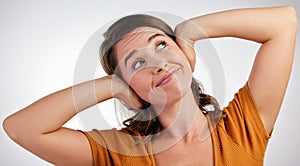 All I here is blah blah blah. Studio shot of a young woman closing her ears with her hands against a white background.