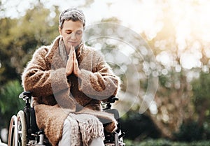 All I need is a miracle right now. a senior woman holding her hands together in prayer while sitting in her wheelchair