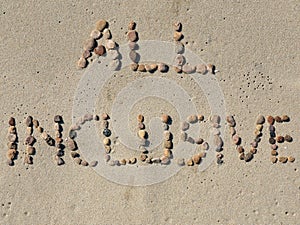 All inclusive text on the beach sand