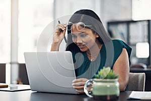 All the inspiration I need is right here. a young businesswoman working on a laptop in an office.