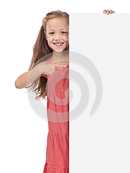 All kids will love this. Studio shot of a young girl holding a blank sign reserved for copyspace.