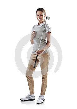 All kitted out for a day on the course. Studio shot of a young golfer holding a golf ball and iron club isolated on