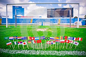 All nations flag on football green grass. Football net and blue sky in background