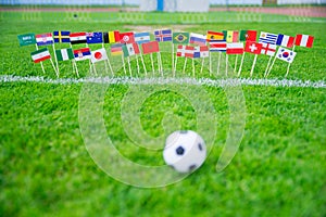 All nations flag on football green grass. Football net and blue sky in background