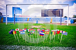 All nations flag on football green grass. Football net and blue sky in background