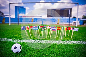 All nations flag on football green grass. Football net and blue sky in background