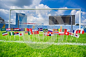 All nations flag on football green grass. Football net and blue sky in background