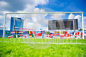 All nations flag on football green grass. Football net and blue sky in background