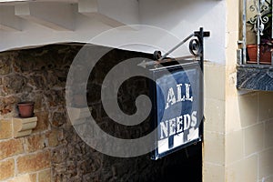 `all needs` sign at the entrance to the builiding photo