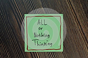 All or Nothing Thinking write on sticky notes isolated on Wooden Table