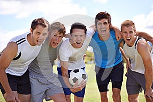 All psyched up. Cropped portrait of a team of soccer players standing on a playing field.