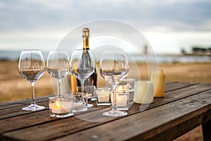 All is ready for the end of year toast in winter holidays by the sea - Celebration scene with selective focus on empty glasses,