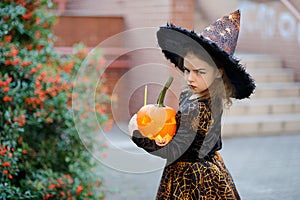 All Saints' Day. Cute little girl portrays the wicked witch.