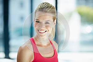 All smiles at the gym. Cropped portrait of an attractive young woman in workout attire.