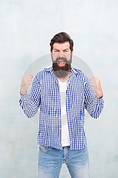 All it takes is all youve got. Happy hipster celebrate victory blue background. Bearded man keep arms upward fingers