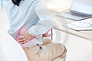 All tensed up and stressed. Closeup shot of an unrecognisable businesswoman experiencing lower back pain while working