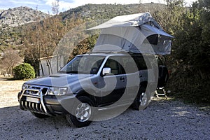 All terrain car with a roof tent