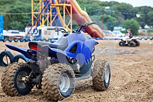 All-terrain vehicle ATV is on sandy beach for rent or driving for fun, cross-country tires