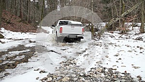 an all terrain vehicle driving through a small river