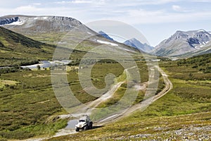All-terrain vehicle rides on the road in the tundra, Yamal