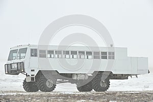 The all-terrain vehicle for snow trips to a snow blizzard in the tundra. Special car for the Arctic safari.