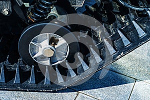 All-terrain vehicle wheel and rubber track. A fragment of highly passable vehicles for places with no roads. Close-up